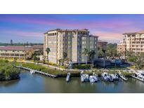 Luxury condo complex featuring private boat slips with waterfront views at dusk at 5531 Cannes Cir # 605, Sarasota, FL 34231