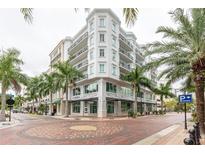 Elegant exterior showcases architectural details, with lush palm trees enhancing its appeal at 1500 State St # 305, Sarasota, FL 34236