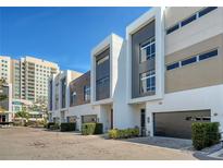 Contemporary townhouses with modern architectural design and well-manicured landscaping at 211 Cosmopolitan Ct, Sarasota, FL 34236