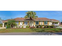 Charming single-story home featuring a well-maintained lawn and a mature palm tree at 303 Grayston Pl # C133, Sun City Center, FL 33573