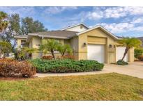 Charming home featuring a two-car garage, well-maintained landscaping, and a welcoming facade at 308 28Th W St, Palmetto, FL 34221