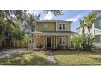 Charming two-story home featuring a covered front porch, landscaped yard, and inviting curb appeal at 311 E Ross Ave, Tampa, FL 33602