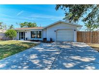 Inviting home exterior featuring a spacious driveway and landscaped front yard at 3285 Datura Rd, Venice, FL 34293