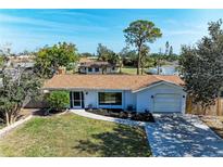 Charming single-story home with a well-manicured lawn and attached garage at 3285 Datura Rd, Venice, FL 34293