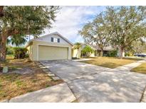 Quaint one-story home with long driveway and attached two-car garage at 406 116Th E St, Bradenton, FL 34212