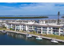 Scenic aerial view of waterfront condos with boat docks, lush landscaping, and calming water views at 4390 Exeter Dr # I305, Longboat Key, FL 34228