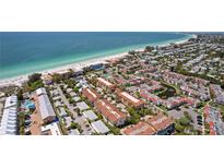 Stunning aerial view of beachfront condos with lush landscaping near the ocean at 224 17Th St # 224, Bradenton Beach, FL 34217