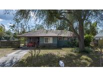 Charming single-story home with a well-maintained lawn and mature trees, offering shade and curb appeal at 2784 Martin St, Sarasota, FL 34237