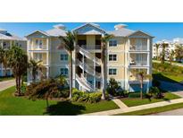 Coastal condo exterior with palm trees and white staircases at 3404 79Th Street W Cir # 301, Bradenton, FL 34209