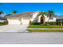 Charming home with manicured lawn, tile roof, and a spacious three-car garage at 5063 Timber Chase Way, Sarasota, FL 34238