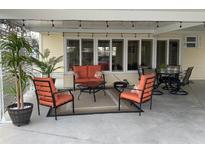 Inviting covered patio with stylish furniture, perfect for outdoor relaxation and entertaining guests at 5075 Tri Par Dr, Sarasota, FL 34234