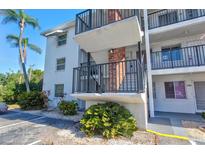 Condo building exterior with stairway and landscaping on a sunny day at 5855 Palm Ln # B21, Bradenton, FL 34207