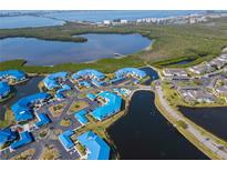 Stunning aerial view of a charming coastal community with blue rooftops and beautiful waterfront scenery at 866 Audubon Dr, Bradenton, FL 34209