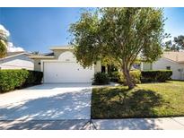 Charming single Gathering home featuring a two-car garage and a well-maintained, green lawn at 9590 Knightsbridge Cir, Sarasota, FL 34238