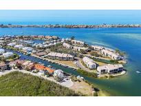 Stunning aerial view of waterfront homes, private docks and boats with ocean views at 3850 Mariners Walk # 713, Cortez, FL 34215
