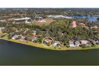 Waterfront property with mature landscaping; community features; views of the lake and surrounding neighborhood at 5036 Willow Leaf Way, Sarasota, FL 34241