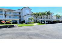 Well-maintained condo complex with covered parking and tropical landscaping at 8735 Olde Hickory Ave # 8210, Sarasota, FL 34238