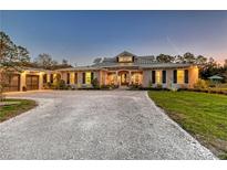 Charming single-story home featuring a circular driveway and lush landscaping at 19610 66Th E Ave, Bradenton, FL 34211