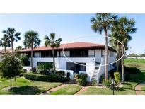 Inviting two-story condo featuring lush landscaping and a red tile roof at 3500 El Conquistador Pkwy # 336, Bradenton, FL 34210