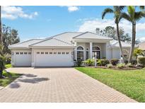 Beautiful home featuring a paver driveway, three-car garage, tile roof and meticulously manicured lawn at 6626 The Masters Ave, Lakewood Ranch, FL 34202