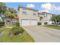 Two-story townhouse with dual garage, red tile roof, and well-maintained landscaping at 7232 Cedar Hollow Cir # 7232, Bradenton, FL 34203