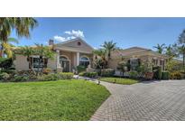 Charming one-story home with manicured lawn, elegant walkway, and lush tropical landscaping at 7303 Westminster Ct, University Park, FL 34201