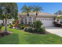 Charming home showcasing manicured lawn and vibrant landscaping, creating a welcoming curb appeal at 7608 Teal Trce, Bradenton, FL 34203