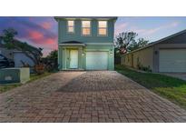 Inviting two-story home featuring a brick-paved driveway and a single-car garage at 1122 42Nd E Ter, Bradenton, FL 34208