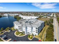 Stunning aerial view of the condo complex near the water with well-maintained grounds and ample parking at 2001 Bal Harbor Blvd # 2301, Punta Gorda, FL 33950