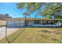 Charming single-story home with a large screened in porch and fenced front yard at 2202 21St W St, Bradenton, FL 34205