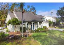 Charming single-story home featuring manicured landscaping, a well-kept lawn, and a double-door entrance at 3301 River Woods Dr, Parrish, FL 34219