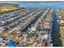 Waterfront property featuring a private pool, boat dock, and stunning views of the canal at 4119 Royal Palm Dr, Bradenton, FL 34210