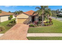 Charming single-story home featuring a tile roof, two-car garage, and well-manicured landscaping at 4802 68Th Street E Cir, Bradenton, FL 34203