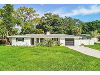 Charming single-story home featuring a well-manicured lawn and a classic, neutral color palette at 6624 Fairway Dr, Sarasota, FL 34243