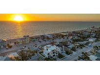 Stunning aerial view of a beachfront home near the ocean at sunset at 1210 Gulf Blvd, Englewood, FL 34223