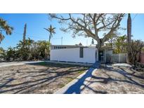 Modern exterior with unique architecture and mature trees offering shade and character to the property at 132 Harrison Dr, Sarasota, FL 34236