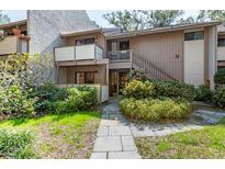 Inviting two-story townhome featuring a private entrance and lush landscaping at 1680 Brookhouse Cir # 110, Sarasota, FL 34231