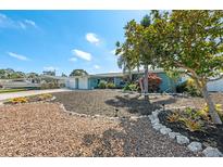 Charming single-story home featuring lush landscaping and a well-maintained front yard at 1728 Bayonne St, Sarasota, FL 34231