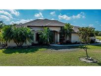 Attractive single story home featuring manicured landscaping, healthy green lawn and a covered front entryway at 2002 Palm View Rd, Sarasota, FL 34240
