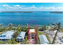 Waterfront home with dock and boat lift, offering direct access to stunning blue waters at 2306 Canasta Dr, Bradenton Beach, FL 34217