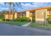 Charming condo exterior with well-maintained landscaping and beautiful architectural details, including screened in balconies at 2431 Bayshore Gardens Pkwy # 19, Bradenton, FL 34207