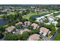Aerial view of a golf community and lush landscaping surrounding two-story condo buildings at 6726 Fairview Ter # 6726, Bradenton, FL 34203