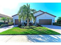 Charming single-Gathering home with well-manicured lawn and brick driveway, plus two-car garage at 324 Whispering Palms Ln, Bradenton, FL 34212