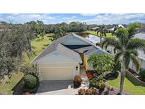 An aerial shot reveals this home's position on a beautiful lot with pond views and mature landscaping at 1407 Morning Sky Gln, Bradenton, FL 34208