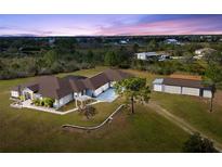 Expansive property featuring a custom home, detached garage, lush landscaping and plenty of room to roam at 25605 69Th E Ave, Myakka City, FL 34251