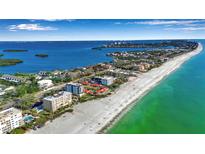 Stunning aerial view of waterfront property with a pristine white sand beach and clear turquoise water at 4234 Gulf Of Mexico Dr # H2, Longboat Key, FL 34228