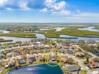 Bright aerial view of a waterfront home in a vibrant community with a lake view at 4809 11Th Avenue E Cir, Bradenton, FL 34208