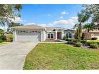 Charming single-story home featuring a well-maintained lawn and two-car garage at 209 111Th E St, Bradenton, FL 34212