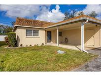 Cozy home with a carport, offering a neat lawn, garden, and easy access to the entrance at 4608 Park Acres Dr, Bradenton, FL 34207