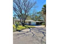 Charming single-story home featuring an attached garage and a cozy carport at 4928 Amherst Ct, New Port Richey, FL 34652